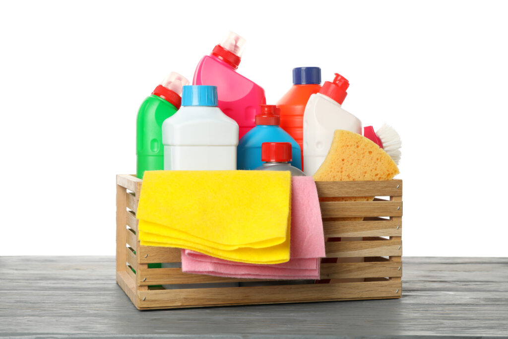 Group of cleaning tools on wooden table isolated on white background